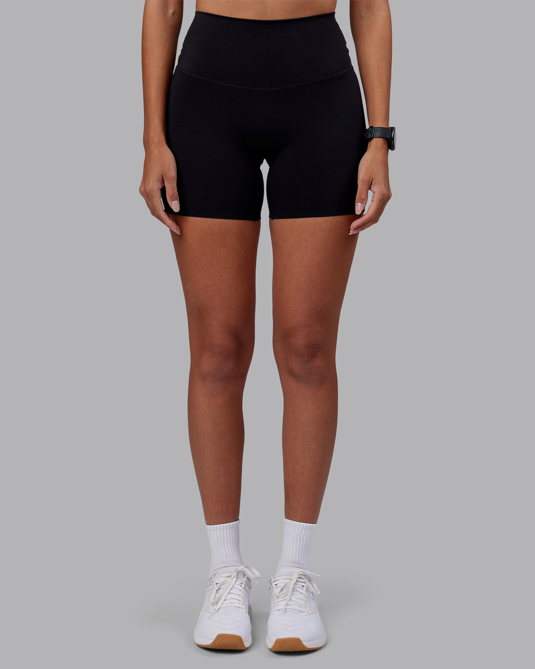 Woman wearing Elixir High-Rise 6" Short - Black | Model:Rhiley | Size:S - view 1