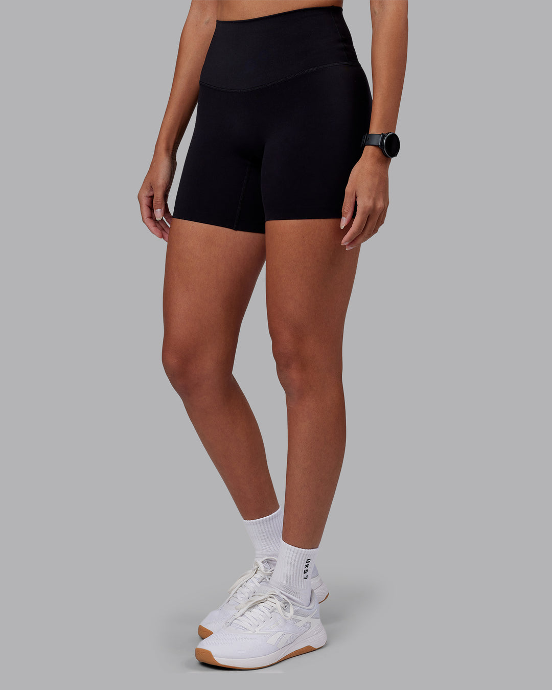 Woman wearing Elixir High-Rise 6" Short - Black | Model:Rhiley | Size:S - view 7