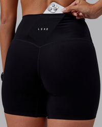 Woman wearing Elixir High-Rise 6" Short - Black | Model:Rhiley | Size:S | Thumbnail Index: 1