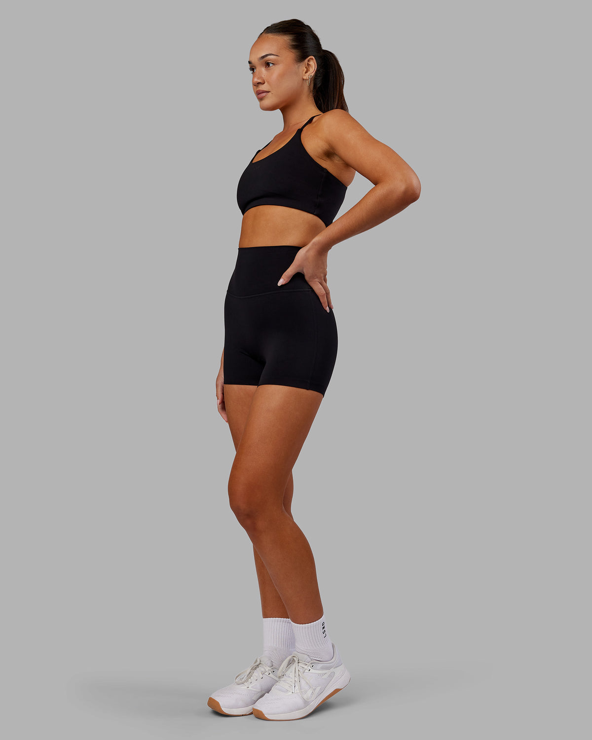 Woman wearing Elixir Ultra High-Rise 4" Short - Black | Model:Kirstyn | Size:S