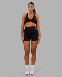 Woman wearing Elixir Ultra High-Rise 4" Short Pockets - Black | Model:Kirstyn | Size:S | Thumbnail Index: 1