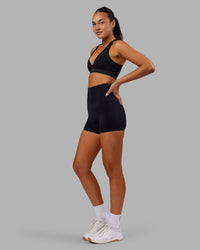 Woman wearing Elixir Ultra High-Rise 4" Short Pockets - Black | Model:Kirstyn | Size:S | Thumbnail Index: 4