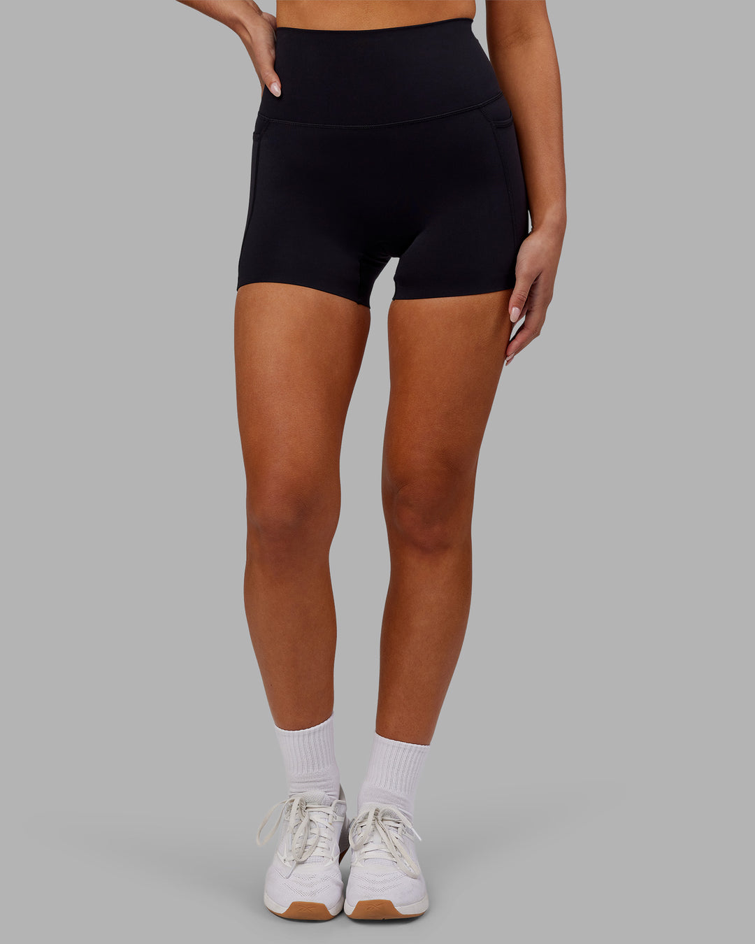 Woman wearing Elixir Ultra High-Rise 4" Short Pockets - Black | Model:Kirstyn | Size:S - view 6