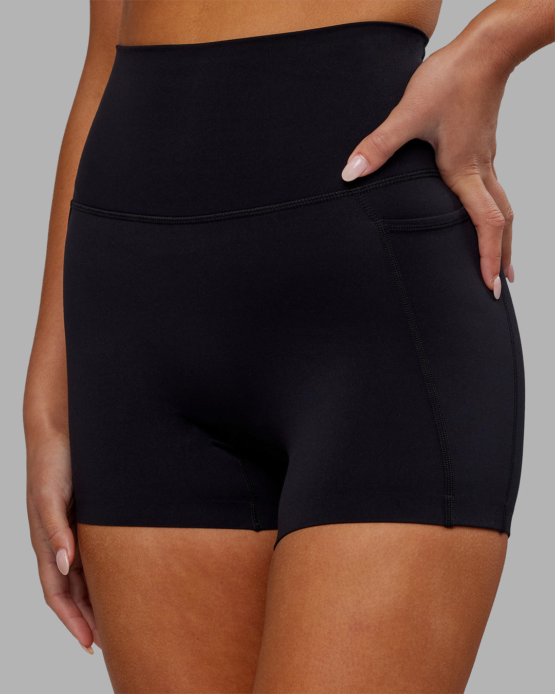 Woman wearing Elixir Ultra High-Rise 4" Short Pockets - Black | Model:Kirstyn | Size:S - view 3