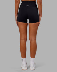 Woman wearing Elixir Ultra High-Rise 4" Short Pockets - Black | Model:Kirstyn | Size:S | Thumbnail Index: 3