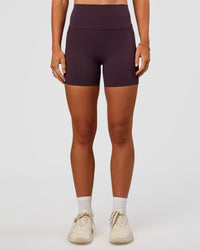 Woman wearing Elixir Ultra High-Rise 4" Short Pockets - Midnight Plum | Model:Emelia | Size:S | Thumbnail Index: 1