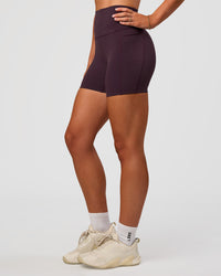 Woman wearing Elixir Ultra High-Rise 4" Short Pockets - Midnight Plum | Model:Emelia | Size:S | Thumbnail Index: 7