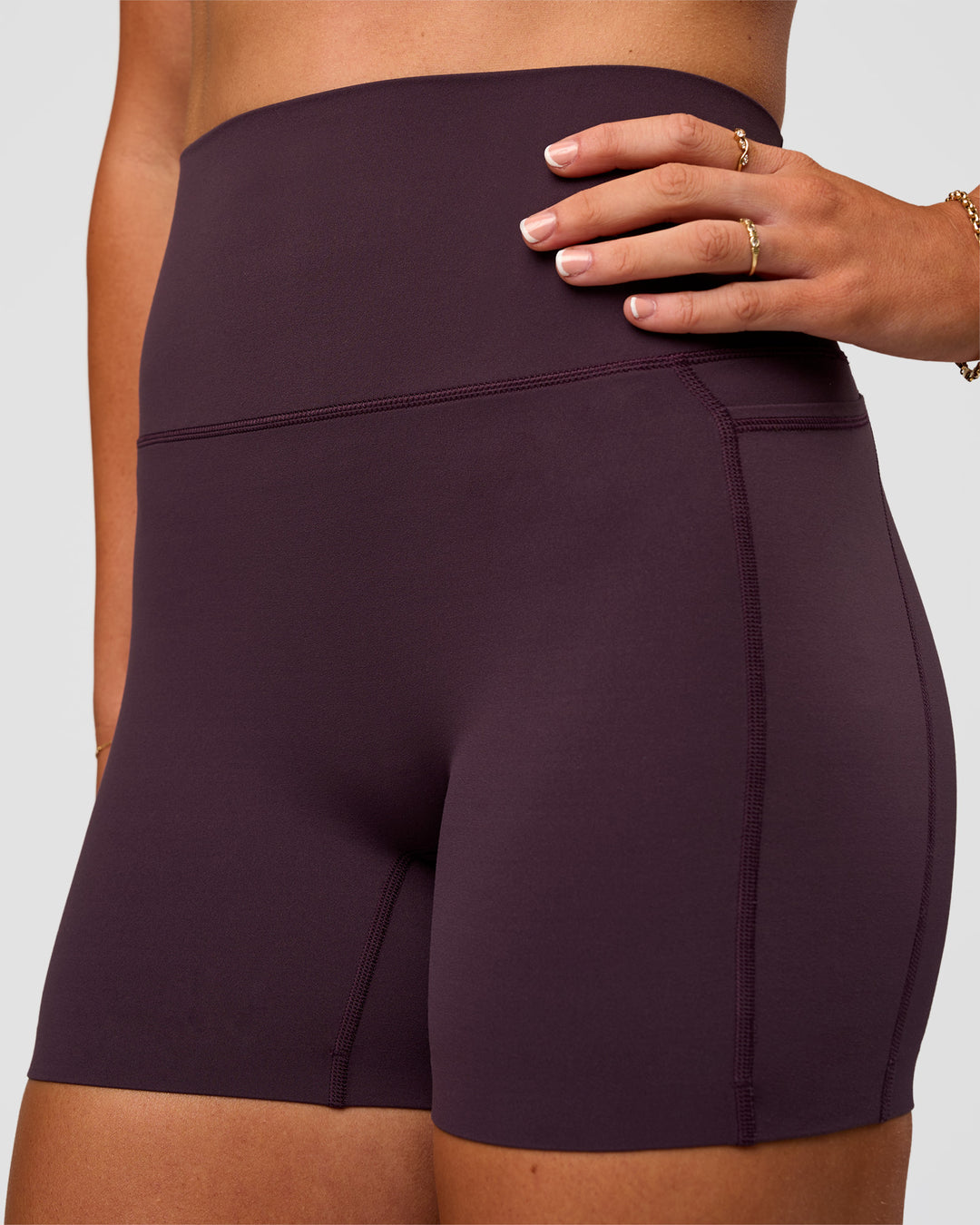 Woman wearing Elixir Ultra High-Rise 4" Short Pockets - Midnight Plum | Model:Emelia | Size:S - view 6