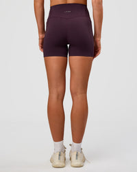 Woman wearing Elixir Ultra High-Rise 4" Short Pockets - Midnight Plum | Model:Emelia | Size:S | Thumbnail Index: 6