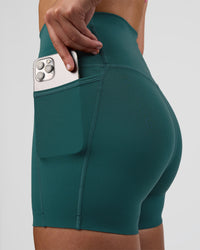 Woman wearing Elixir Ultra High-Rise 4" Short Pockets - Transformative Teal | Model:Myrte | Size:S | Thumbnail Index: 0