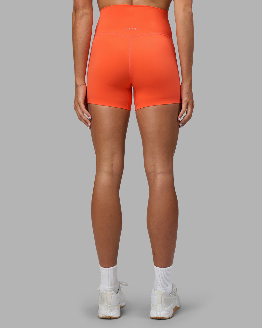 Woman wearing Elixir Ultra High-Rise 4" Short - Ultra Orange | Model:Katie | Size:S - view 4