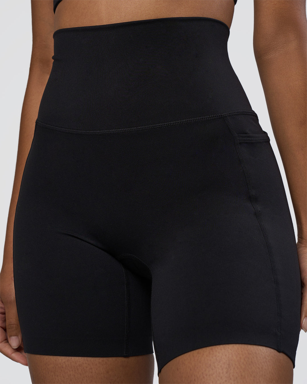 Woman wearing Elixir Ultra High-Rise 6" Short Pockets - Black | Model:Jordan | Size:S - view 3