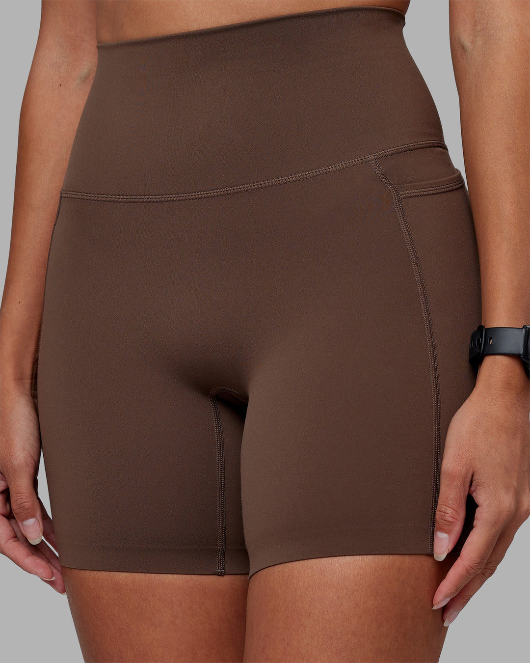 Woman wearing Elixir Ultra High-Rise 6" Short Pockets - Chocolate Martini | Model:Rhiley | Size:S - view 11