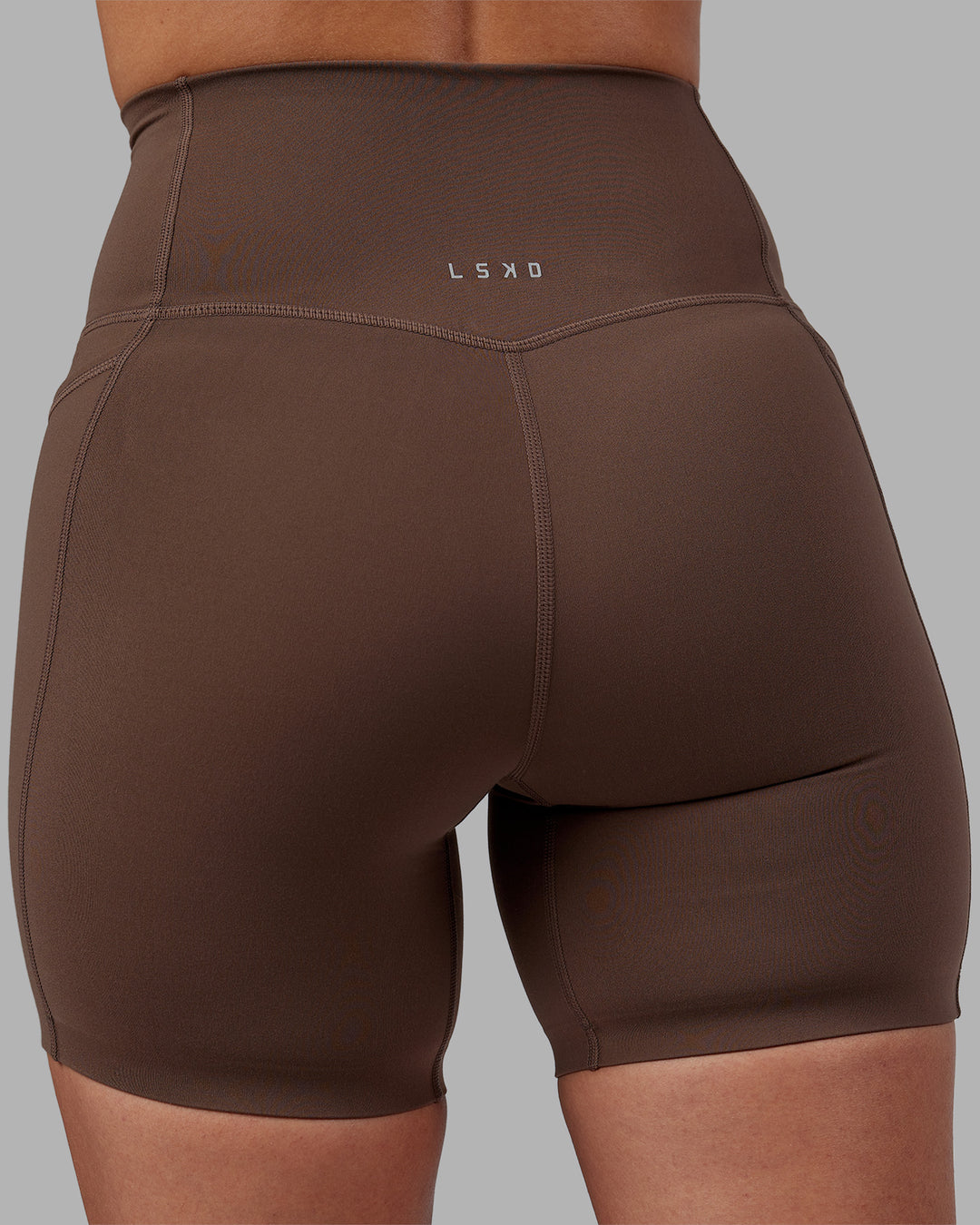 Woman wearing Elixir Ultra High-Rise 6" Short Pockets - Chocolate Martini | Model:Rhiley | Size:S - view 15