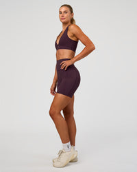 Woman wearing Elixir Ultra High-Rise 6” Short Pockets - Midnight Plum | Model:Emelia | Size:S | Thumbnail Index: 9
