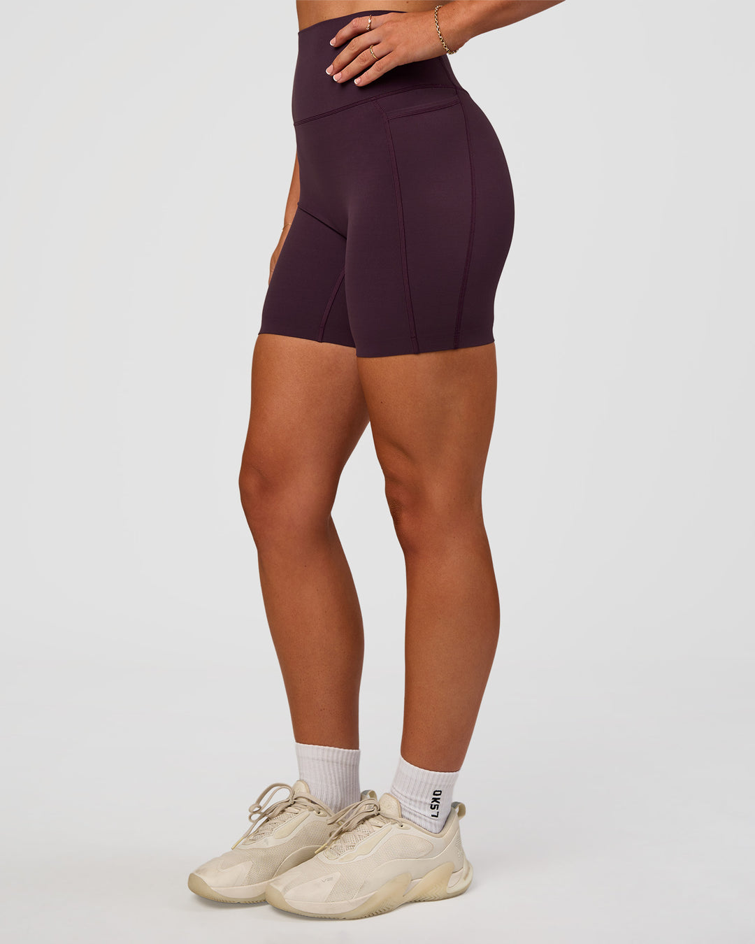 Woman wearing Elixir Ultra High-Rise 6” Short Pockets - Midnight Plum | Model:Emelia | Size:S - view 1