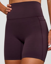 Woman wearing Elixir Ultra High-Rise 6” Short Pockets - Midnight Plum | Model:Emelia | Size:S | Thumbnail Index: 8