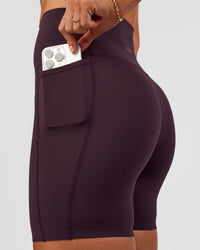 Woman wearing Elixir Ultra High-Rise 6” Short Pockets - Midnight Plum | Model:Emelia | Size:S | Thumbnail Index: 3
