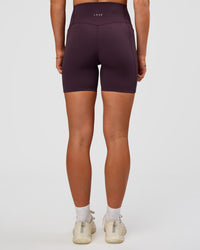 Woman wearing Elixir Ultra High-Rise 6” Short Pockets - Midnight Plum | Model:Emelia | Size:S | Thumbnail Index: 4