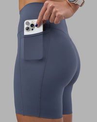 Woman wearing Elixir Ultra High-Rise 6" Short Pockets - Night Shadow | Model:Phoebe | Size:S | Thumbnail Index: 0