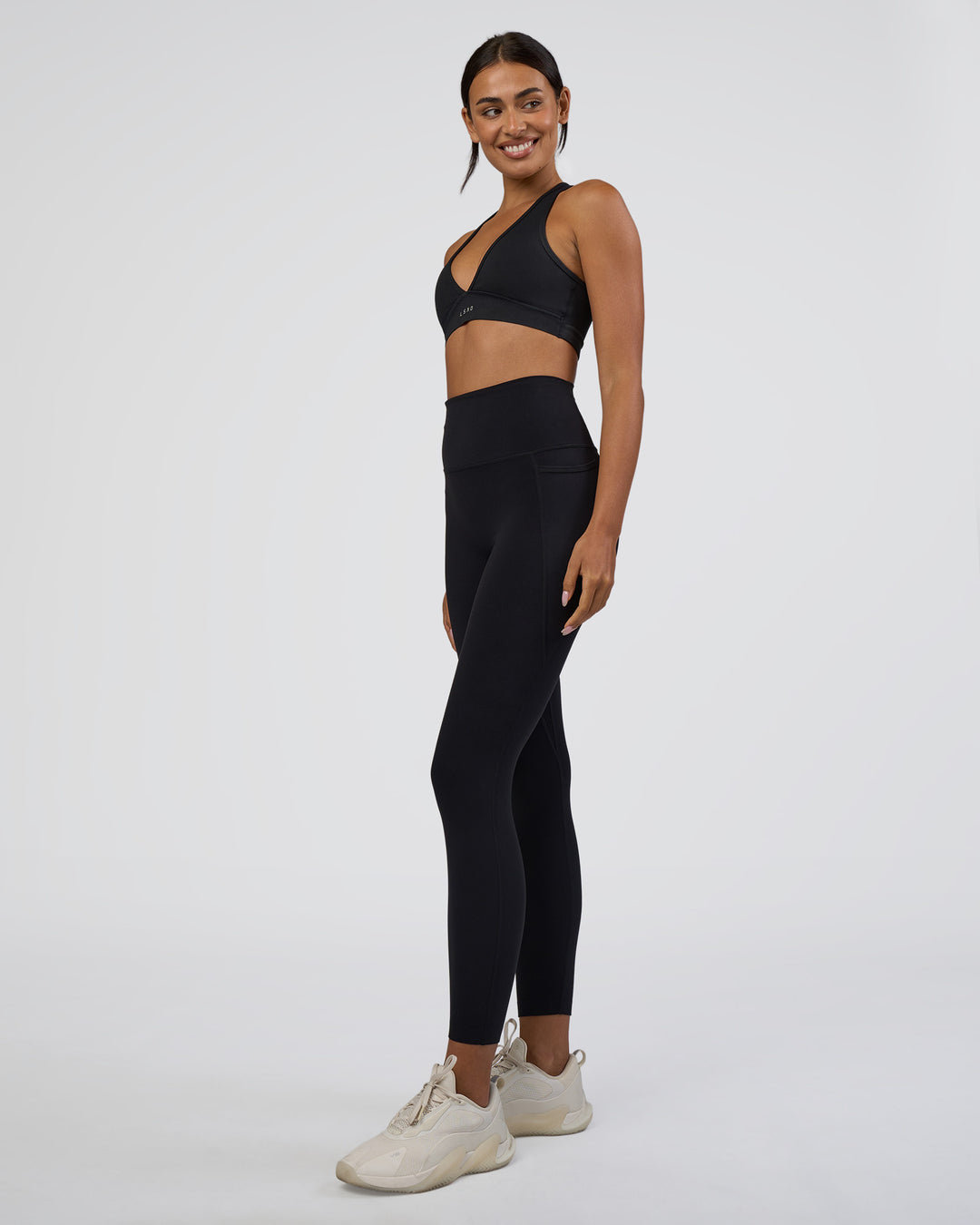 Woman wearing Elixir Ultra High-Rise 7/8 Legging Pockets - Black | Model:Ruby | Size:S - view 2