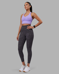 Woman wearing Elixir Ultra High-Rise 7/8 Legging Pockets - Dark Storm Wash | Model:Rhiley | Size:S | Thumbnail Index: 0