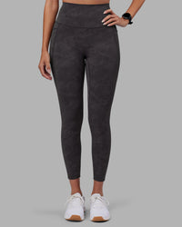 Woman wearing Elixir Ultra High-Rise 7/8 Legging Pockets - Dark Storm Wash | Model:Rhiley | Size:S | Thumbnail Index: 1