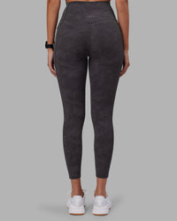 Woman wearing Elixir Ultra High-Rise 7/8 Legging Pockets - Dark Storm Wash | Model:Rhiley | Size:S | Thumbnail Index: 3