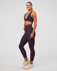 Woman wearing Elixir Ultra High-Rise 7/8 Legging Pockets - Midnight Plum | Model:Emelia | Size:S | Thumbnail Index: 6