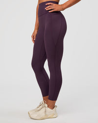 Woman wearing Elixir Ultra High-Rise 7/8 Legging Pockets - Midnight Plum | Model:Emelia | Size:S | Thumbnail Index: 7
