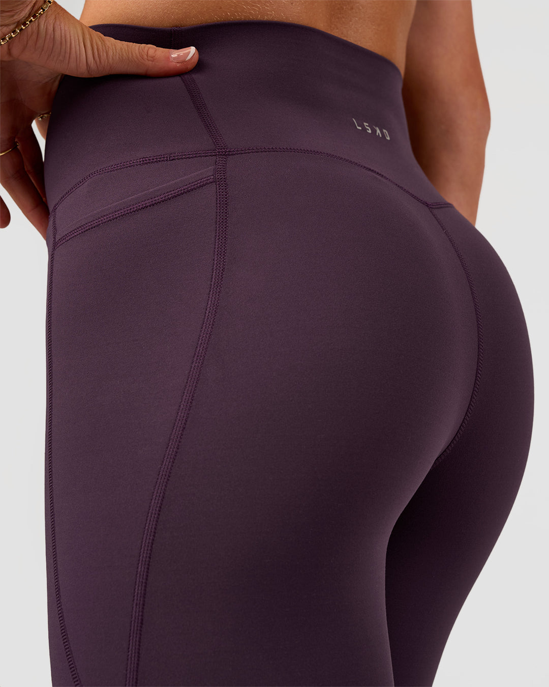 Woman wearing Elixir Ultra High-Rise 7/8 Legging Pockets - Midnight Plum | Model:Emelia | Size:S - view 9