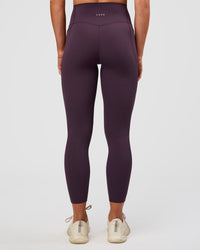 Woman wearing Elixir Ultra High-Rise 7/8 Legging Pockets - Midnight Plum | Model:Emelia | Size:S | Thumbnail Index: 2