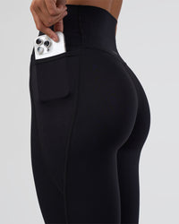 Woman wearing Elixir Ultra High-Rise Full Length Legging Pockets - Black | Model:Amity | Size:S | Thumbnail Index: 6