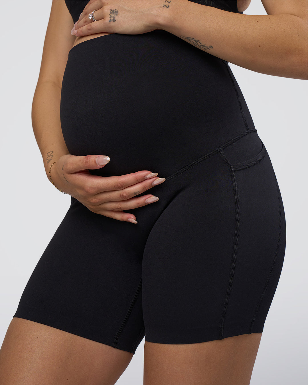 Woman wearing Elixir Ultra High-Rise Maternity 6" Short Pockets - Black | Model:Kitahna | Size:S - view 6