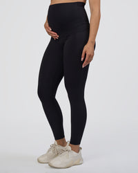 Woman wearing Elixir Ultra High-Rise Maternity Full Length Legging Pockets - Black | Model:Kitahna | Size:S | Thumbnail Index: 1