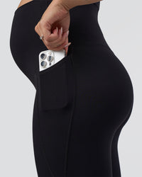 Woman wearing Elixir Ultra High-Rise Maternity Full Length Legging Pockets - Black | Model:Kitahna | Size:S | Thumbnail Index: 5