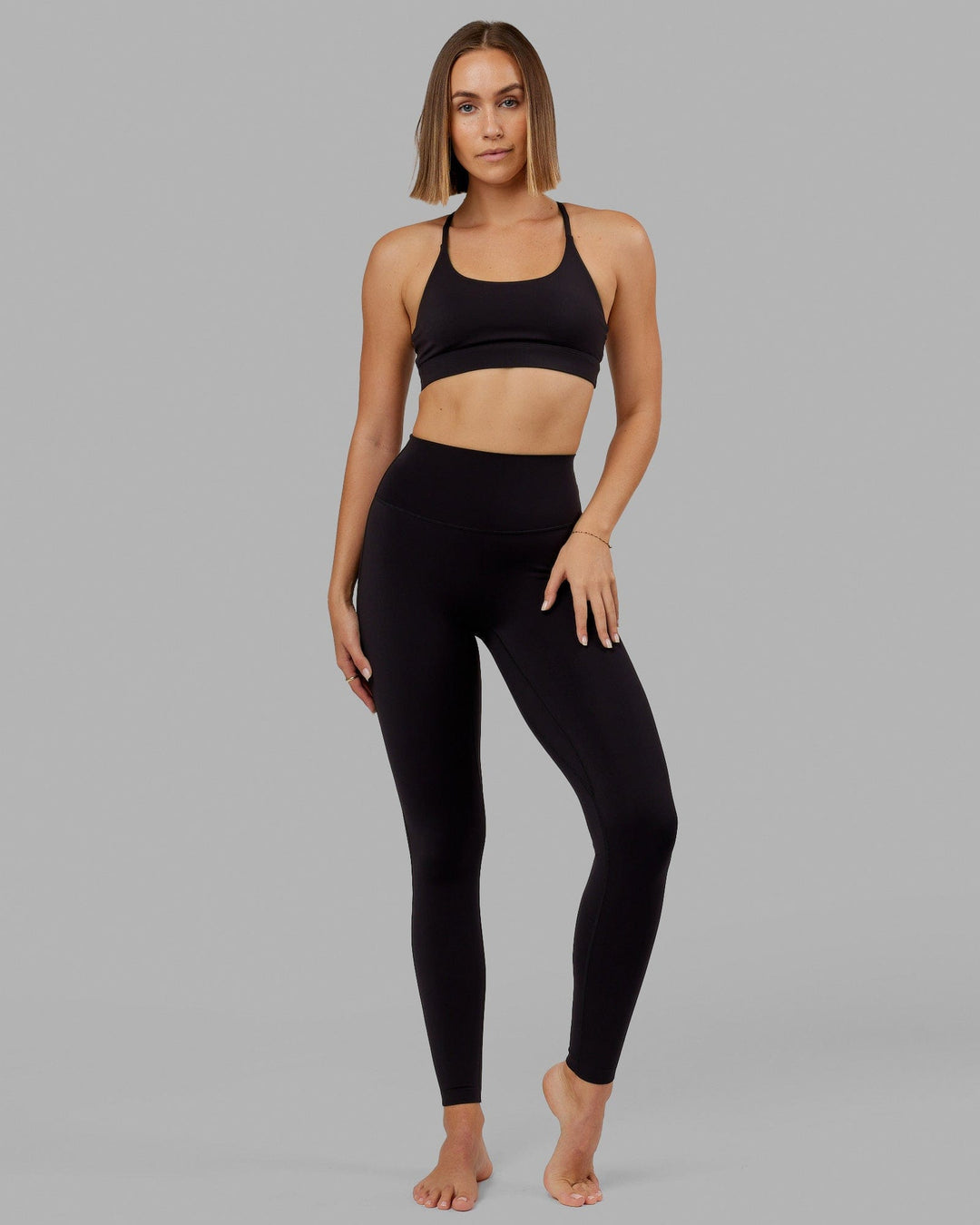 Woman wearing Elixir Ultra High-Rise Tall Legging - Black - view 1