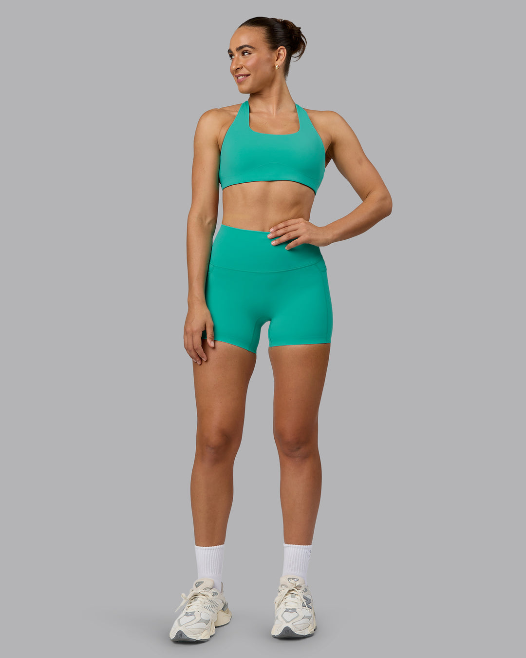 Woman wearing Elixir Ultra High-Rise 4" Short Pockets - Atlantis | Model:Sophie | Size:S - view 1