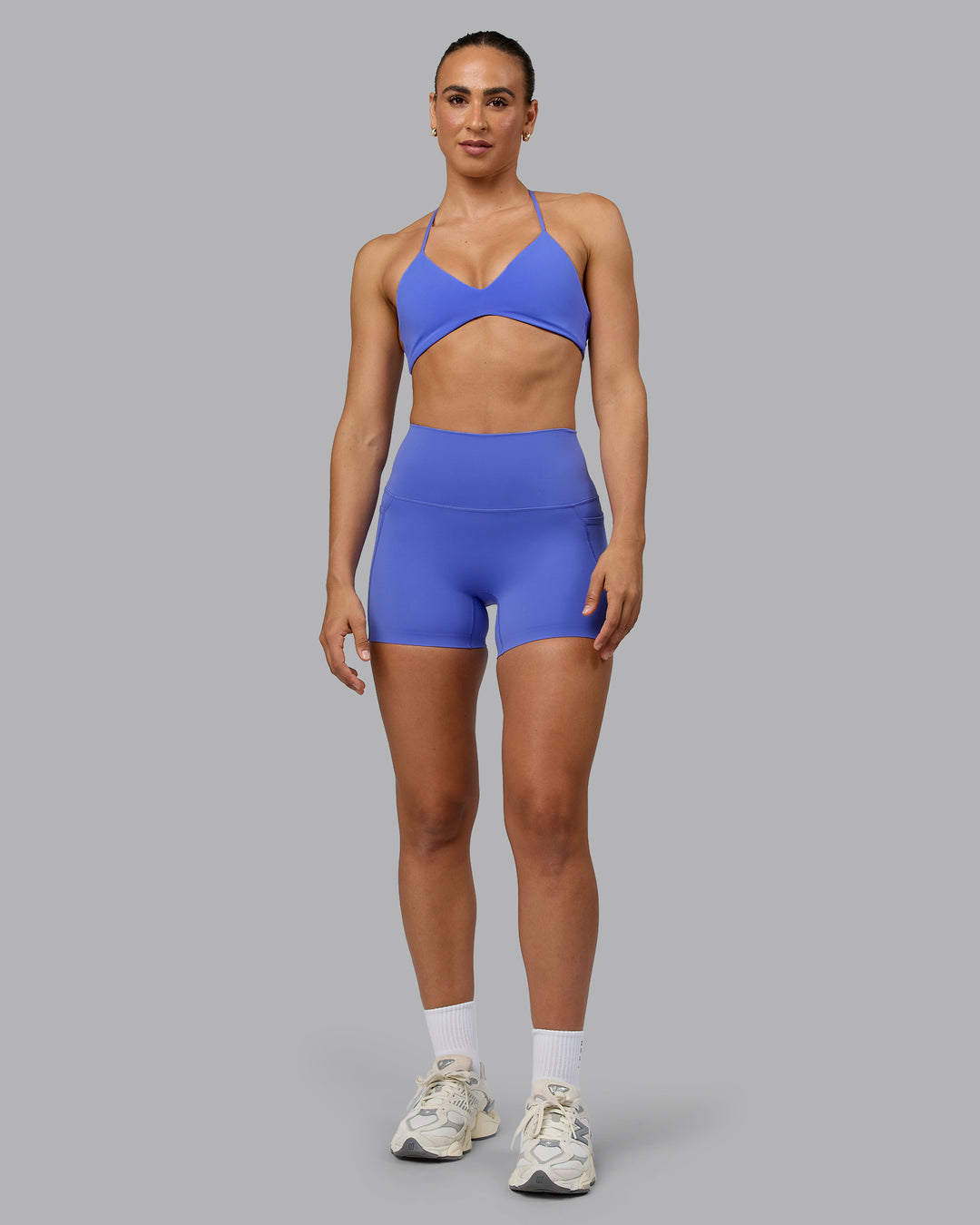 Woman wearing Elixir Ultra High-Rise 4" Short Pockets - Baja Blue | Model:Sophie | Size:S - view 3
