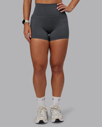 Woman wearing Elixir Ultra High-Rise 4" Short Pockets - Dark Storm | Model:Lyss | Size:S | Thumbnail Index: 0