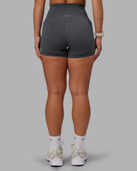 Woman wearing Elixir Ultra High-Rise 4" Short Pockets - Dark Storm | Model:Lyss | Size:S | Thumbnail Index: 3