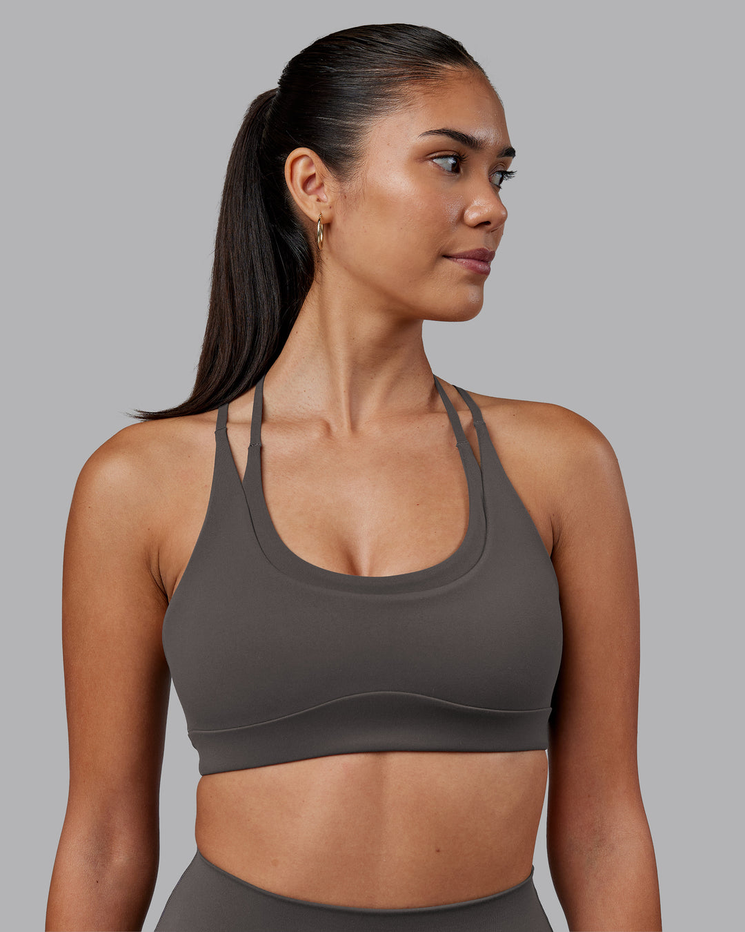 Woman wearing Empower Sports Bra - Dark Storm | Model:Rhiley | Size:S - view 1