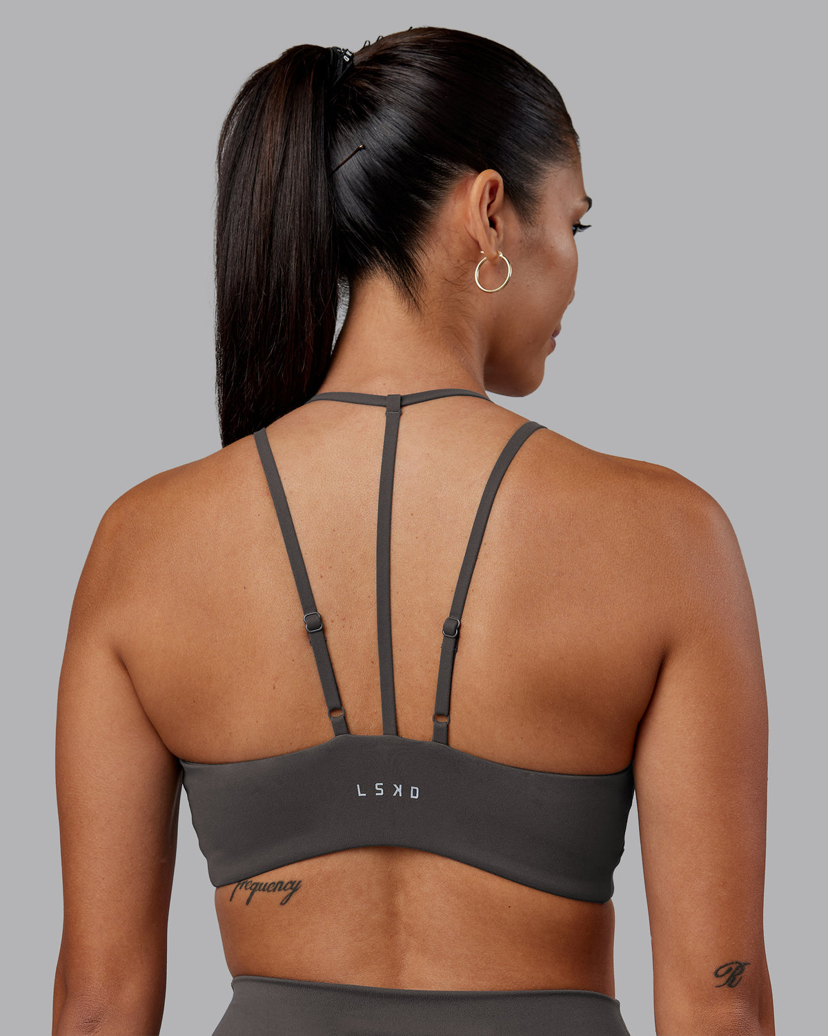 Woman wearing Empower Sports Bra - Dark Storm | Model:Rhiley | Size:S