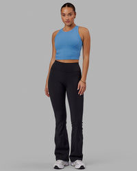 Woman wearing Fusion Ultra High-Rise Flared Legging Pockets - Black | Model:Milly | Size:S | Thumbnail Index: 4