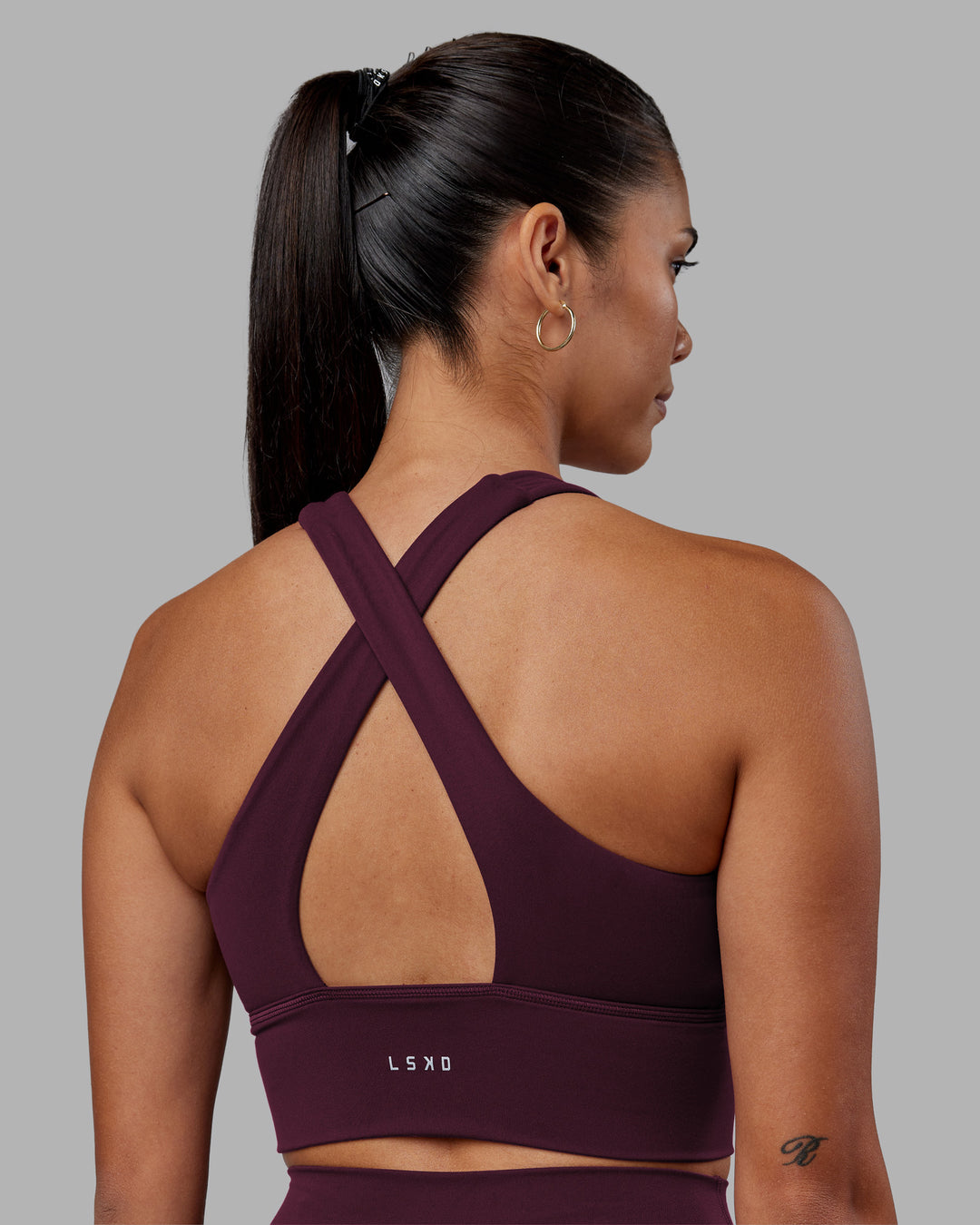 Woman wearing Evoke Longline Sports Bra - Cherry Lacquer | Model:Rhiley | Size:S - view 2