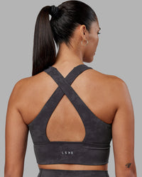 Woman wearing Evoke Longline Sports Bra - Dark Storm Wash | Model:Rhiley | Size:S | Thumbnail Index: 1