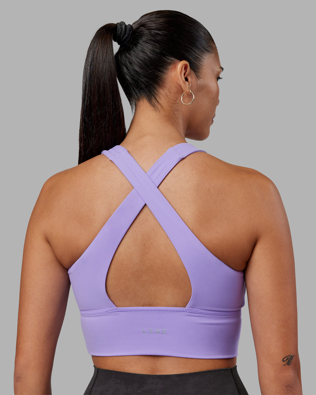 Woman wearing Evoke Longline Sports Bra - Violet Ray | Model:Rhiley | Size:S - view 1