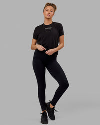 Woman wearing Fitstop Fast Tee - Black | Thumbnail Index: 1