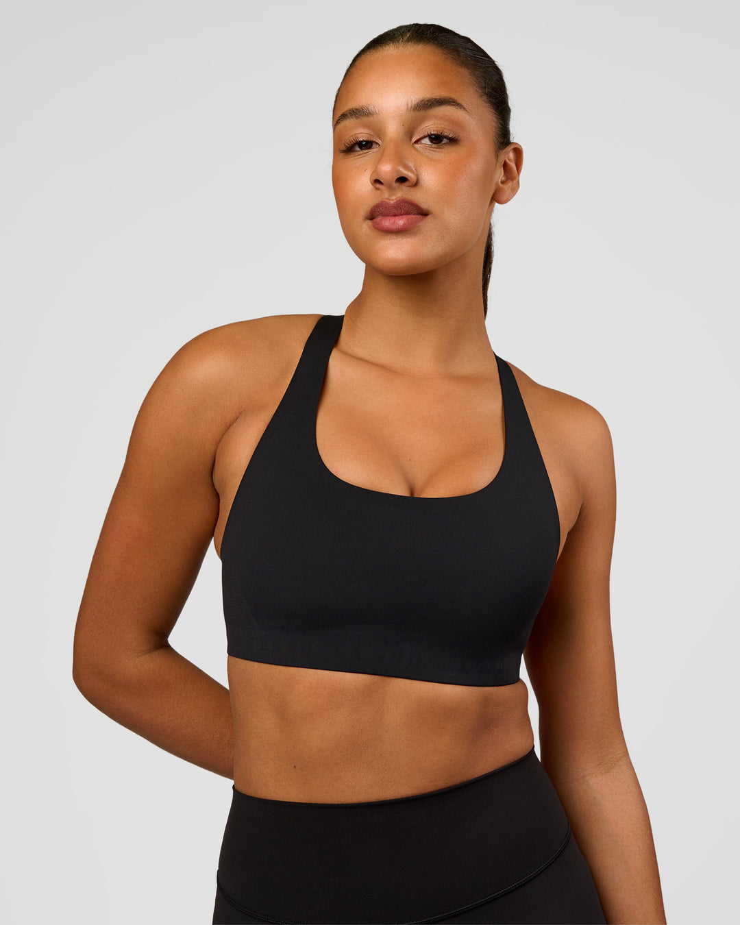 Woman wearing Flow Bonded Scoop Neck Sports Bra - Black | Model:Rosie | Size:S - view 6