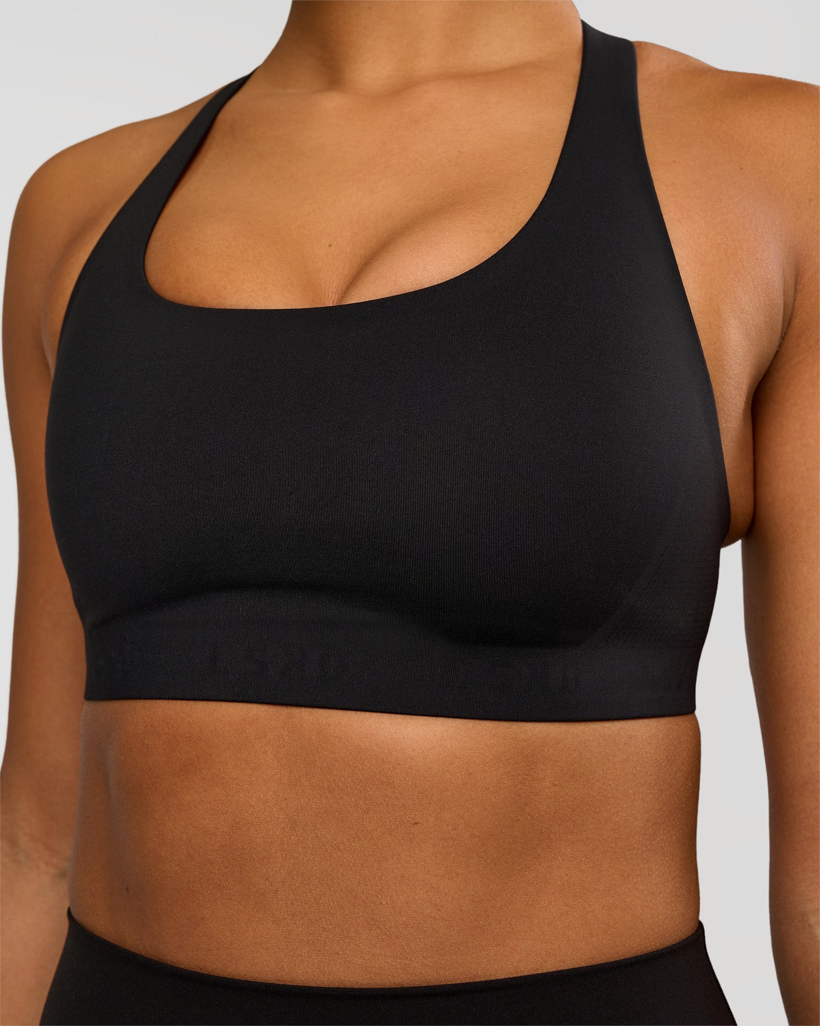 Woman wearing Flow Bonded Scoop Neck Sports Bra - Black | Model:Rosie | Size:S